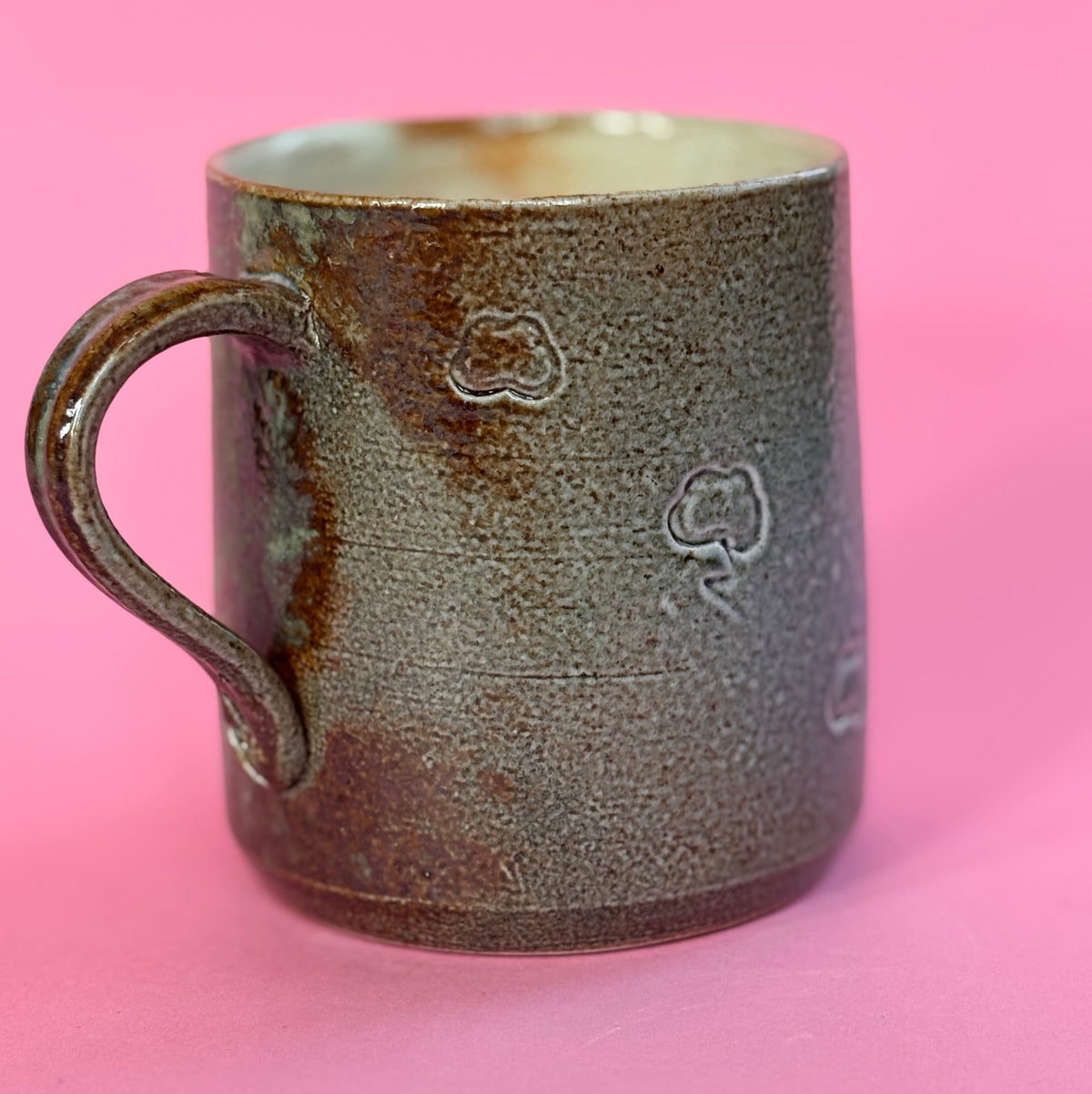 Salt fired mug with sprayed ash glaze