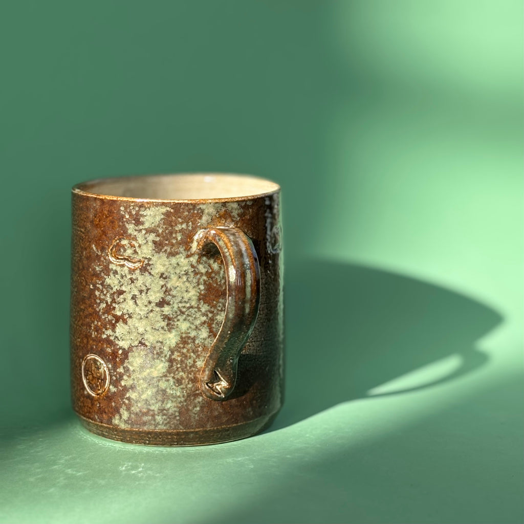 Salt fired mug with sprayed ash glaze