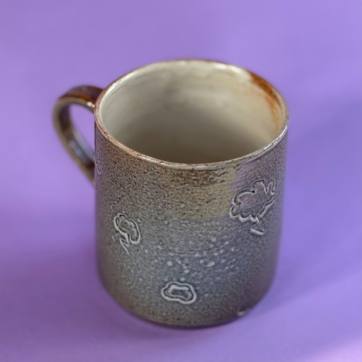 Salt fired mug with sprayed ash glaze
