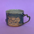 Impish cat mug