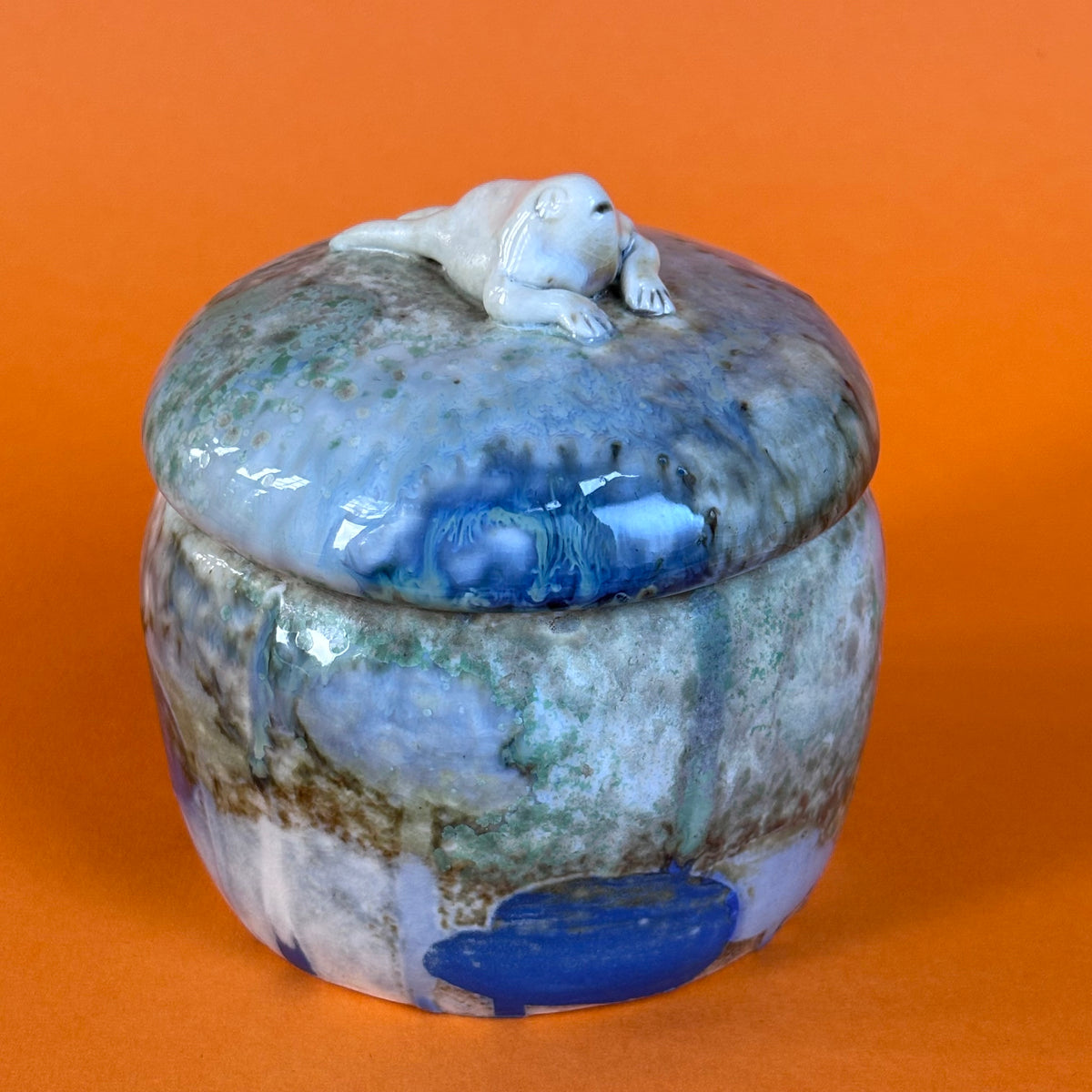 Lidded jar with butted frog
