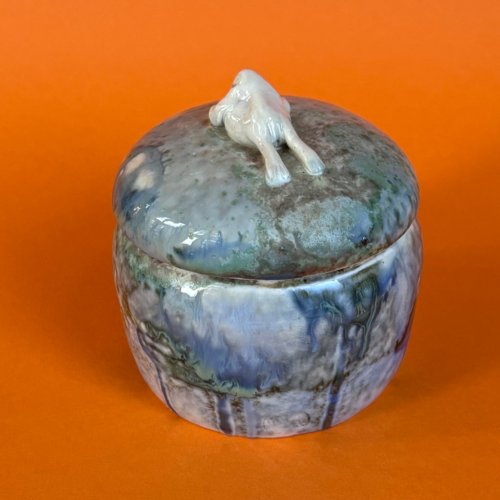 Lidded jar with butted frog