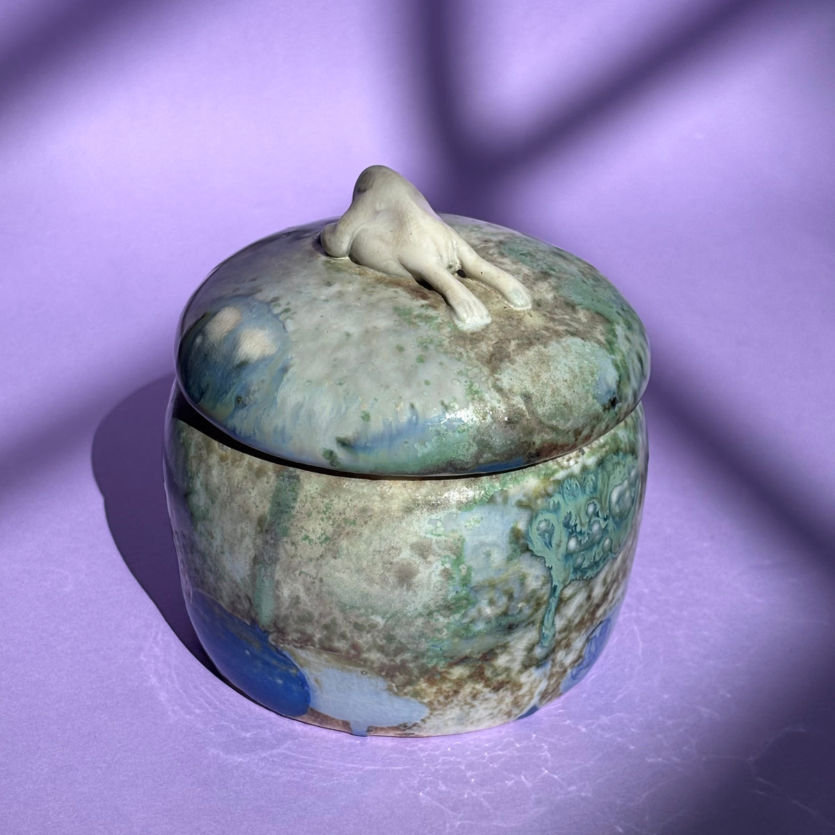 Lidded jar with butted frog