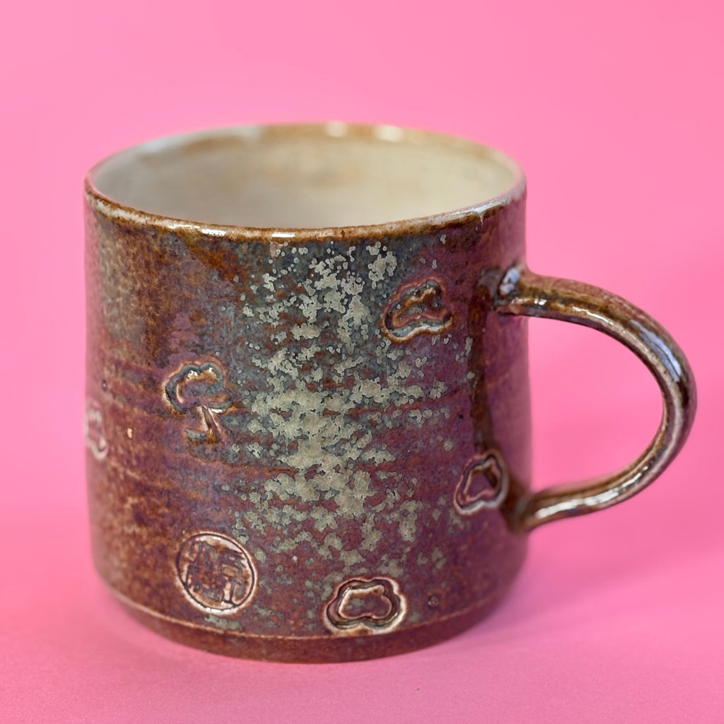 Salt fired mug with sprayed ash glaze