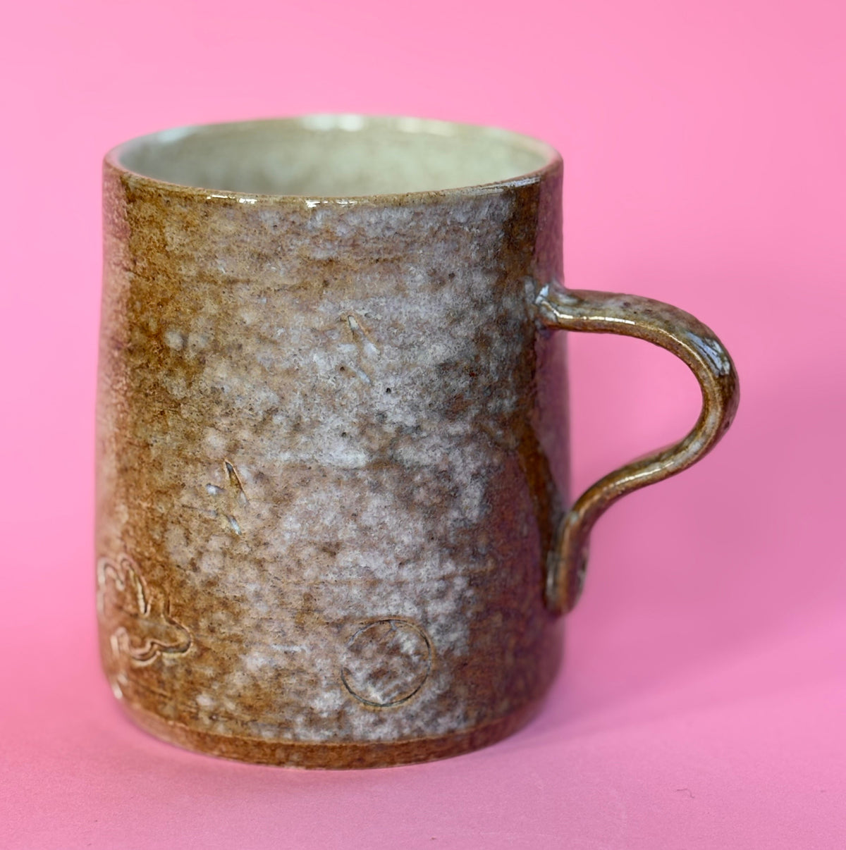 Salt fired mug with sprayed titanium glaze