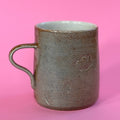 Salt fired mug with sprayed titanium glaze
