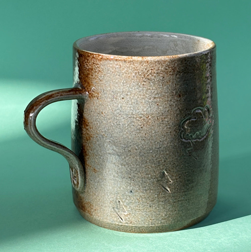 Salt fired mug with sprayed titanium glaze