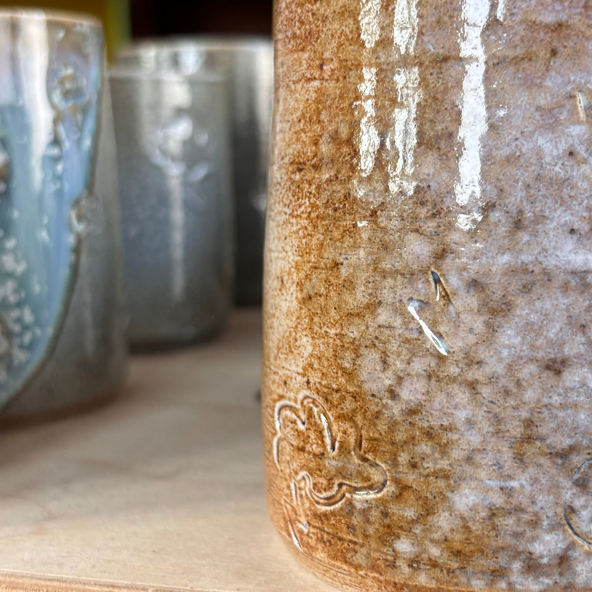 Salt fired mug with sprayed titanium glaze